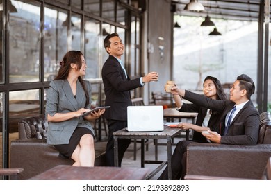 Relaxed Business Worker Enjoy Drinking After Finishing The Meeting With Partner In Coffe Shop