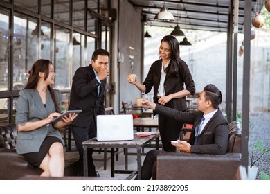 Relaxed Business Worker Enjoy Drinking After Finishing The Meeting With Partner In Coffe Shop