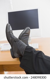 Relaxed businessman with his feet up in his office