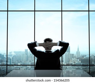 Relaxed Businessman Sitting In Office