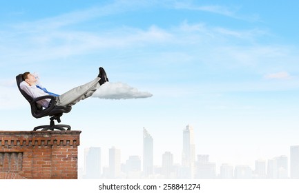 Relaxed Businessman Sitting On Chair With Legs Up