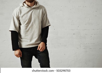 Relaxed Calm Athletic Young Man With A Beard Wearing Black Jeans, Black Longsleeve T-shirt And A Plain Heather Grey Comfy Hoodie Isolated On White