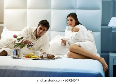 Relaxed Couple In Bed, Hotel Room