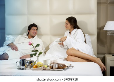 Relaxed Couple In Bed, Hotel Room