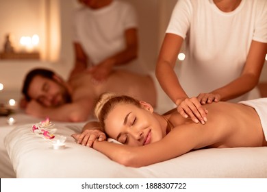 Relaxed Couple Enjoying Massage And Aromatherapy Lying With Eyes Closed On Beds In Luxury Spa. Relaxing Body Care Treatment, Wellness And Relaxation Concept. Selective Focus, Low Light