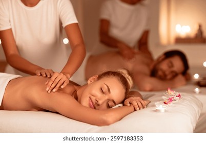 Relaxed Couple Enjoying Massage And Aromatherapy Lying With Eyes Closed On Beds In Luxury Spa. Relaxing Body Care Treatment, Wellness And Relaxation Concept. Selective Focus, Low Light