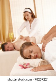 Relaxed Couple Having Back Massage In Day Spa.