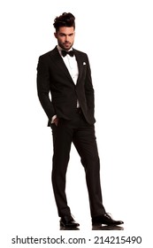 Relaxed Elegant Man In Tuxedo Looking At The Camera On White Background