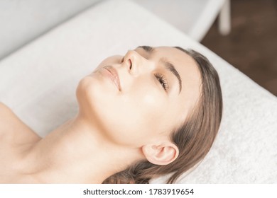 Relaxed face of young woman lying down in beauty salon - Shutterstock ID 1783919654