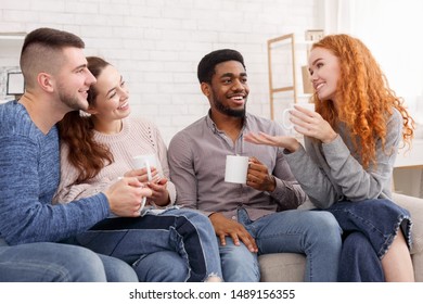 Relaxed Friends Drinking Coffee And Chatting, Enjoying Their Company At Home