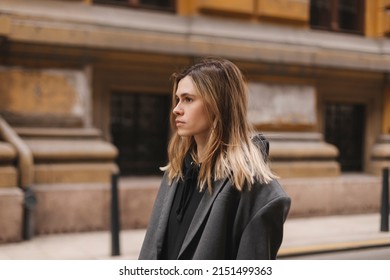 Relaxed Girl Walking City Street Alone Closeup. Tourist Woman Crosswalk On Spring Or Fall Weekend. Attractive Lady Exploring Beautiful Town District On Vacation. Girl Wear Grey Minimalistic Jacket.