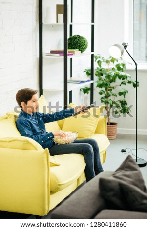 Similar – A teenage boy stretches down, pulling his head to his knees, outdoors