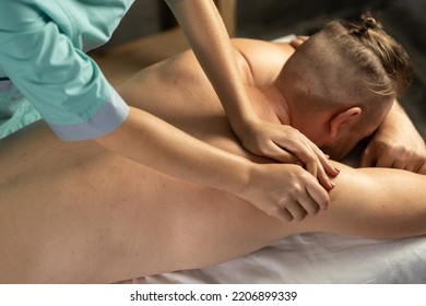 Relaxed Handsome Man Having Body Massage At Spa Salon. Man Attending Modern Male Spa, Getting Healing Body Procedure, Enjoying His Day At Spa Salon