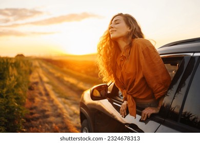 Relaxed happy woman on summer road trip travel in the car. Lifestyle, travel, tourism, nature, active life. - Powered by Shutterstock