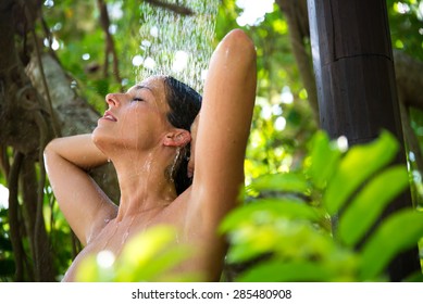 Relaxed Happy Woman Taking Spa Shower Outdoor In Exotic Garden.