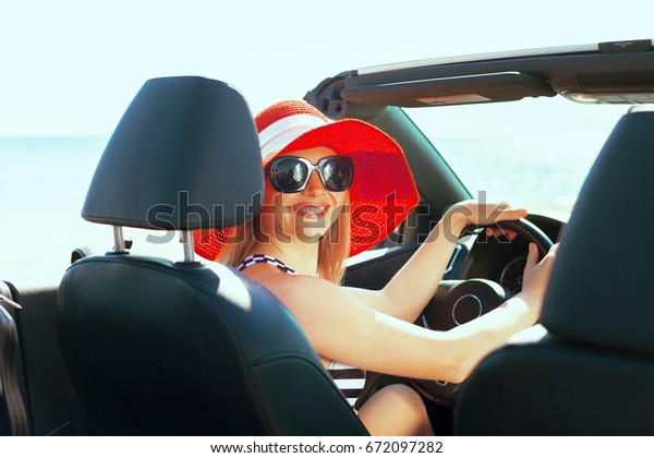 Relaxed happy woman\
traveling in a car
