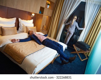relaxed and happy young couple in modern hotel room - Shutterstock ID 322268831