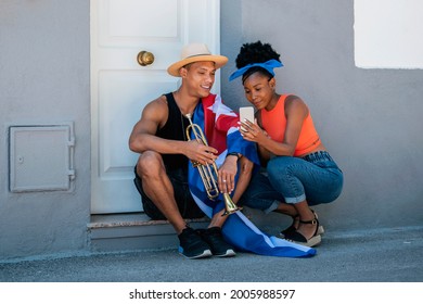 Relaxed Latin American Man And Woman Checking A Phone