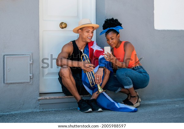 Relaxed\
latin american man and woman checking a\
phone