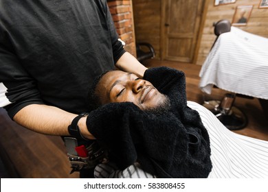 Relaxed man enjoying hot-towel mask before shaving - Powered by Shutterstock