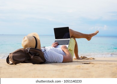 Relaxed Man With Laptop On The Beach