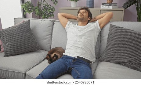 Relaxed man lounging on a couch with a siamese cat in a cozy living room setting. - Powered by Shutterstock