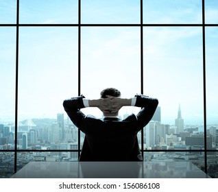 Relaxed Man Sitting In Office