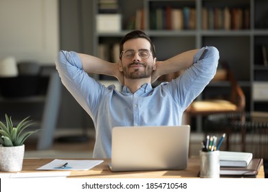 Relaxed man take break from work put hands behind head lean on comfy chair closing eyes feels serenity, enjoy fresh conditioned air in modern office, no stress, fatigue relieve at workplace concept