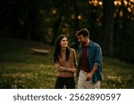 Relaxed man and woman enjoying a peaceful sunset walk surrounded by blooming flowers