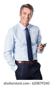 Relaxed Mature Business Man Typing Message On Smartphone And Looking At Camera. Portrait Of A Happy Senior Businessman Using Cell Phone Isolated On White Background. 