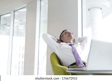 Relaxed Mature Businessman Reclining At Lobby