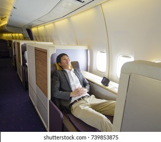 Relaxed Mid Adult Business Man Sleeping In First Class Seat