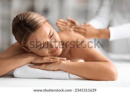 Relaxed Middle Aged Woman Getting Therapeutic Manual Massage In Wellness Center, Calm Beautiful Mature Female Lying On Table With Closed Eyes, Enjoying Body Treatment In Spa Salon, Closeup Shot