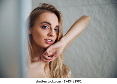 Relaxed Pretty Lady Standing Alone By The Wall