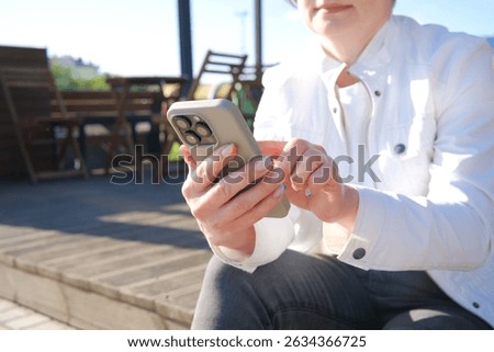 A relaxed scene of someone using a smartphone, capturing the essence of modern communication and connectivity