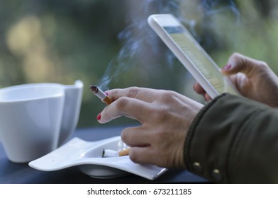 Relaxed While Smoking, Drinking Coffee And Using The Cell Phone.