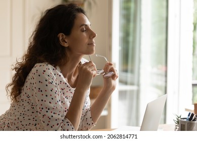 Relaxed Woman, Distance Employee Enjoying Break From Work At Computer From Home, Holding Glasses, Turning Face With Closed Eyes To Open Window, Breathing Fresh Air, Keeping Calm And Silence.