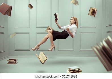 A relaxed woman levitates in a room full of flying books