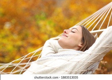 Relaxed woman resting on hammock in fall season in autumn in a forest - Powered by Shutterstock