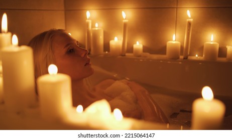 Relaxed Woman Washing Hands In Bath In Slow Motion. Sexy Girl Taking Bathtub With Bubbles And Foam In Slow Motion. Top View Of Pretty Lady Enjoying In Luxury Bathroom With Candles.