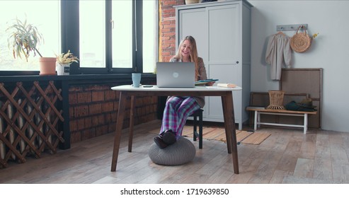 Relaxed Work During Lockdown. Young Smiling Blonde Business Woman In Pajama Pants Works Online Using Laptop Video Call.