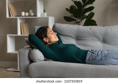 Relaxed young attractive hispanic latina woman lying on comfortable sofa, seeing sweet dreams, sleeping or napping, breathing fresh air, enjoying carefree peaceful weekend alone in living room. - Powered by Shutterstock