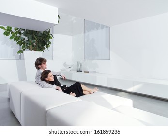 Relaxed Young Couple At Home In Bright Living Room