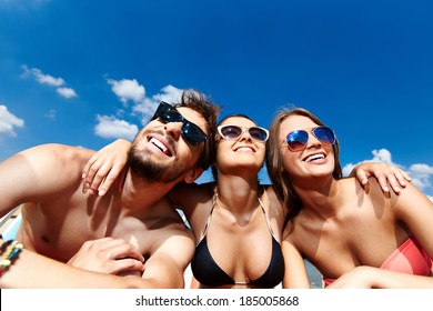 Relaxed Young Friends Having Rest On The Beach