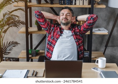 Relaxed young man resting from work on laptop holding hands behind head lean on comfy chair closing eyes feels serenity in home office workplace coworking. Taking Break no stress, fatigue relief - Powered by Shutterstock