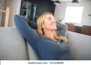 Relaxed young woman enjoying rest on comfortable sofa, calm attractive girl relaxing on couch - Shutterstock ID 1572598900