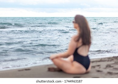 Relaxed young woman laying on sandy beach