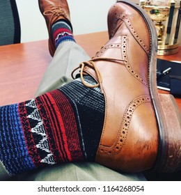 Relaxing After A Hard Work Day. Corporate Men’s Fashion. Dress Shoes And Crazy Socks.