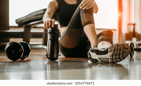 Relaxing after training.beautiful young woman looking away while sitting  at gym.young female at gym taking a break from workout. - Powered by Shutterstock