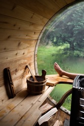 relaxing alone in a personal outdoor sauna in the woods, a window with a view of a forest outside, a Sports & Recreation Photo by Elainery